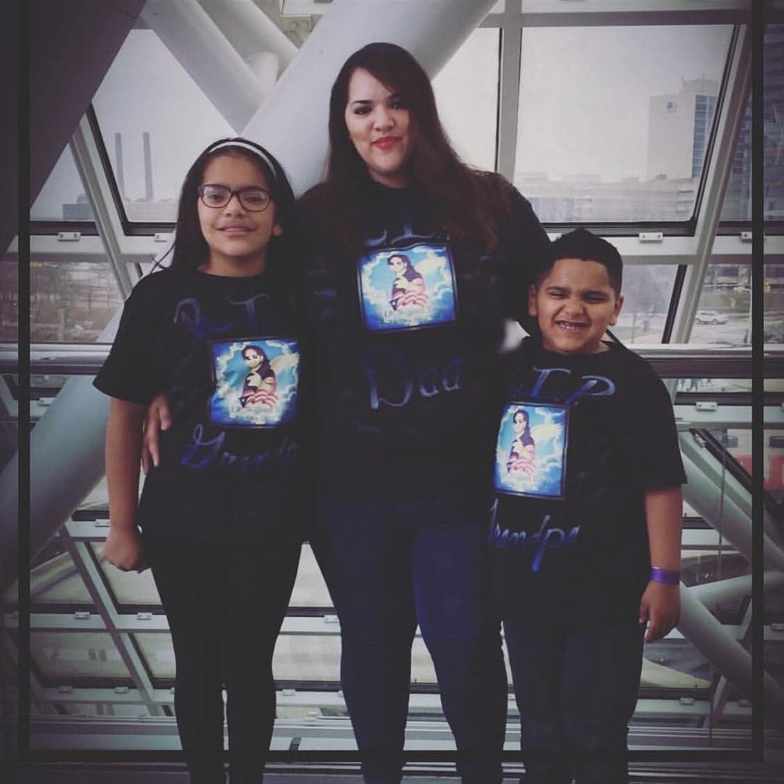 Miriam with her children, all wearing shirts in memory of William